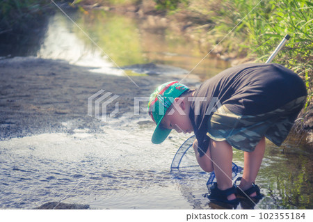 boy playing in the river 102355184