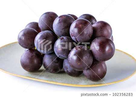 Kyoho grapes served on a ceramic plate 102356283
