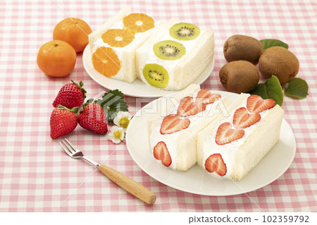 Strawberry, kiwi and orange fruit sandwich on a white round plate Strawberry, kiwi and orange fruit sandwich on a white round plate 102359792
