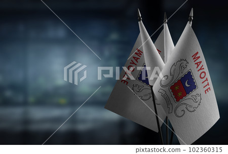Small flags of the Mayotte on an abstract blurry background Small flags of the Mayotte on an abstract blurry background 102360315