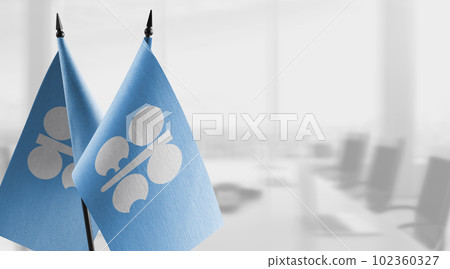 Small flags of the Organization of the Petroleum Exporting Countries on an abstract blurry background Small flags of the Organization of the Petroleum Exporting Countries on an abstract blurry background 102360327