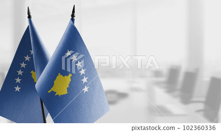 Small flags of the Kosovo on an abstract blurry background 102360336