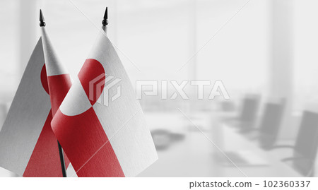 Small flags of the Greenland on an abstract blurry background 102360337