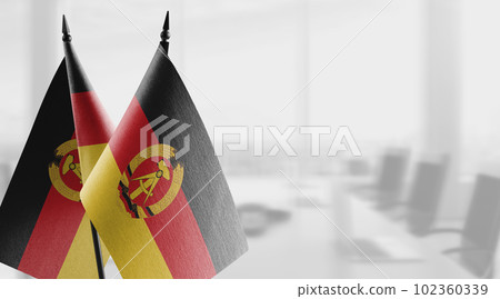 Small flags of the GDR on an abstract blurry background Small flags of the GDR on an abstract blurry background 102360339