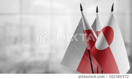 Small flags of the Greenland on an abstract blurry background 102360372