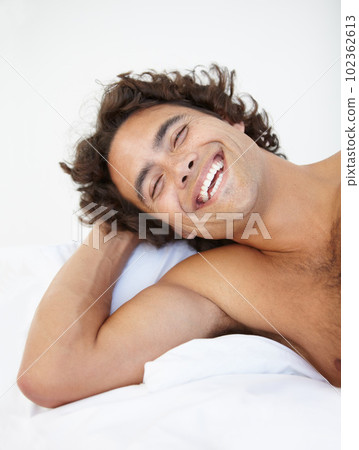 Face, laugh and a handsome man in bed in his home to relax or rest alone on a summer morning. Smile, wellness and lifestyle with a happy young male person relaxing in the bedroom of his house Face, laugh and a handsome man in bed in his home to relax or rest alone on a summer morning. Smile, wellness and lifestyle with a happy young male person relaxing in the bedroom of his house 102362613