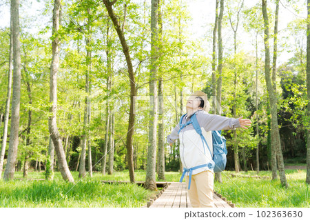 Portrait of senior woman walking in fresh green 102363630