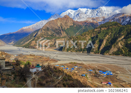 Taiga Kali Gandaki and Nilgiri Peak seen from a village along Jomsom Highway, Nepal 102366241