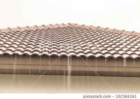 rain falling down from the house roof rain falling down from the house roof 102368161