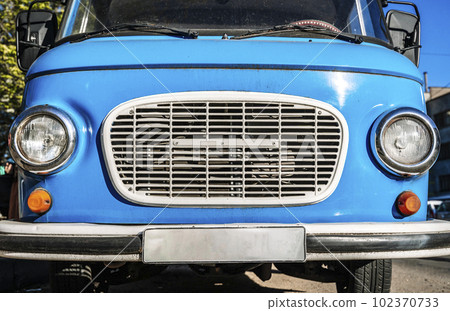 Vintage blue bus. Retro van hippie camper car on sunny street of the city.  102370733