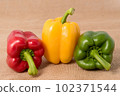 Ripe vibrant colorful peppers on sackcloth 102371544