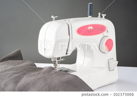 Modern sewing machine with gray fabric 102373008