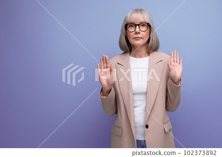 portrait of a nice neat business 60s lady in a stylish look on a studio background with copy space portrait of a nice neat business 60s lady in a stylish look on a studio background with copy space 102373892