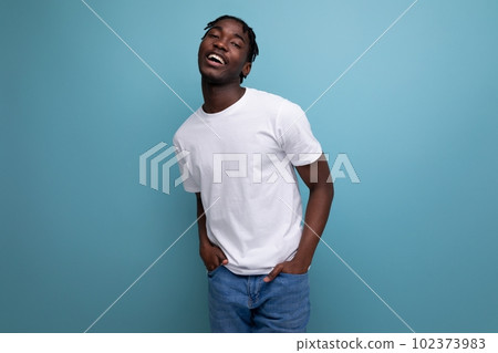 a dark-skinned European young man with dreadlocks is dressed in a white T-shirt for printing a dark-skinned European young man with dreadlocks is dressed in a white T-shirt for printing 102373983