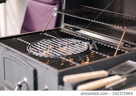 Photo of empty BBQ grill. The fire is burning 102375969