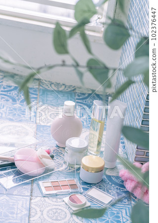 Makeup tools lined up on tiles 102376447