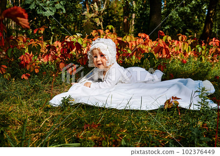 Cute baby explores the world in a sunny forest colorful summer meadow. Cute baby explores the world in a sunny forest colorful summer meadow. 102376449