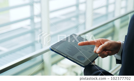 Businessman pointing and confirming at the building Businessman pointing and confirming at the building 102377702