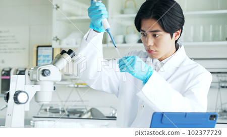 Researcher experimenting in the lab 102377729
