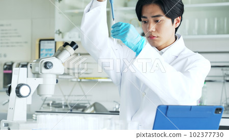 Researcher experimenting in the lab 102377730