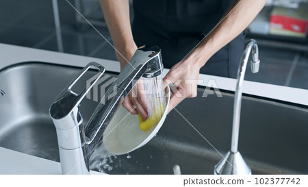 man washing dishes man washing dishes 102377742