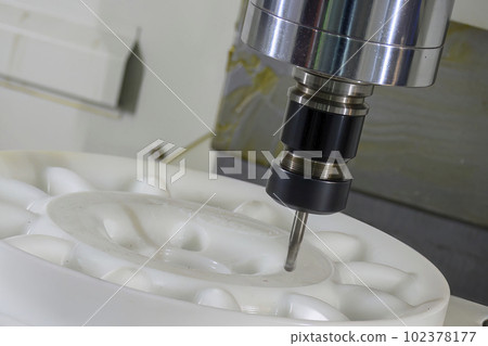 The  CNC milling machine cutting the nylon 6 material part with ball end mill tool. 102378177