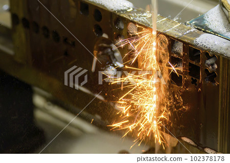 Closeup scene the wire EDM machine cutting the mold insert parts. Closeup scene the wire EDM machine cutting the mold insert parts. 102378178