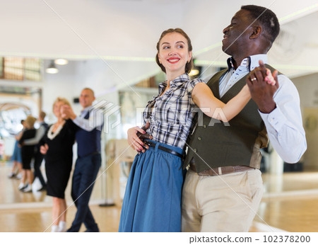 Man and woman performing ballroom dance in dancing room Man and woman performing ballroom dance in dancing room 102378200