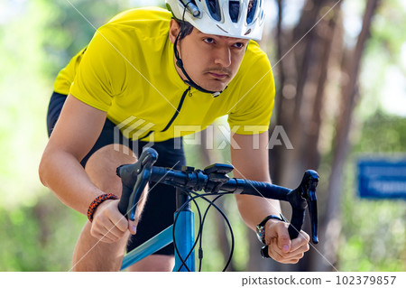 Close-up photo of a young athlete during a bicycle race. 102379857