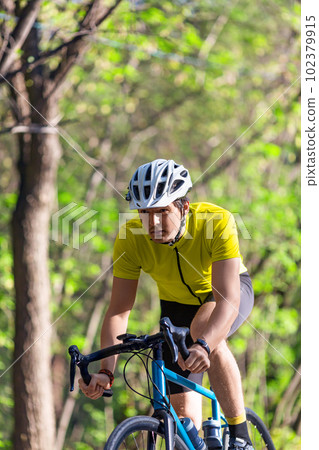 Young athlete during a bicycle race - vertical photo. Young athlete during a bicycle race - vertical photo. 102379915