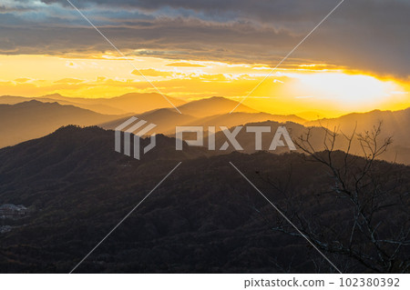 Light beams illuminating the sunset sky and mountains from Nariaiyama Panorama Observatory in Miyazu City, Kyoto Prefecture, Japan Light beams illuminating the sunset sky and mountains from Nariaiyama Panorama Observatory in Miyazu City, Kyoto Prefecture, Japan 102380392