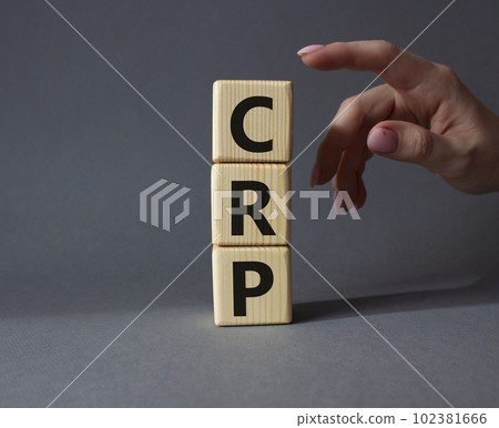CRP - C-Reactive Protein Test symbol. Wooden cubes with word CRP. Doctor hand. Beautiful grey background. Medical and C-Reactive Protein Test concept. Copy space. 102381666
