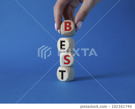 Best symbol. Concept word Best on wooden cubes. Businessman hand. Beautiful blue background. Business and Best concept. Copy space. Best symbol. Concept word Best on wooden cubes. Businessman hand. Beautiful blue background. Business and Best concept. Copy space. 102381740