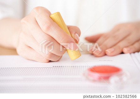 Female hand imprinting documents Female hand imprinting documents 102382566