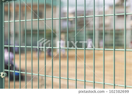 Youth baseball game over the fence 102382699
