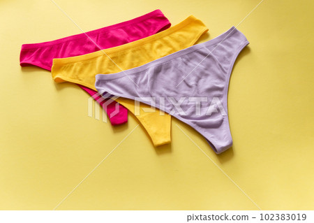 Set of colorful underpants on yellow background, close up 102383019