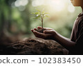 Child hands holding young plant against spring green background. Ecology concept. AI generative 102383450