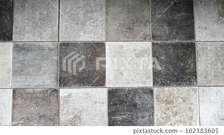 Stone background made of laminate. Square tiles in grey. Placed on the floor. 102383601
