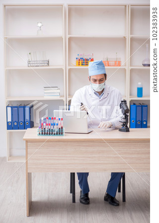 Young male chemist working at the lab Young male chemist working at the lab 102383938
