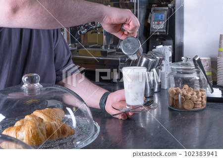 Barista making cappuccino, bartender preparing coffee drink 102383941