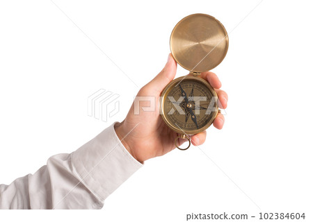 businessman holds a compass to help himself to find the correct way businessman holds a compass to help himself to find the correct way 102384604