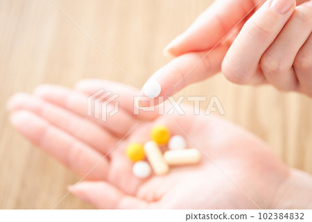 Hand of women with medicine 102384832