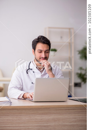 Young male doctor in telemedicine concept Young male doctor in telemedicine concept 102385109