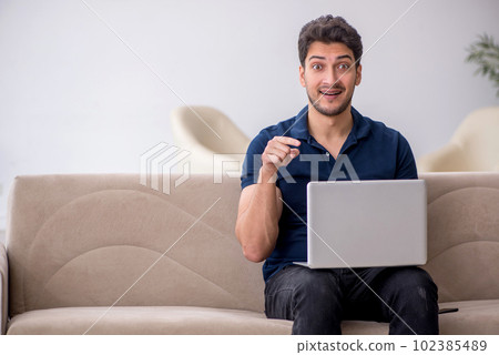 Young male freelancer working from home 102385489