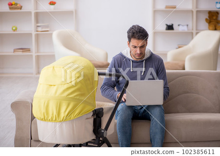 Young man looking after newborn at home Young man looking after newborn at home 102385611