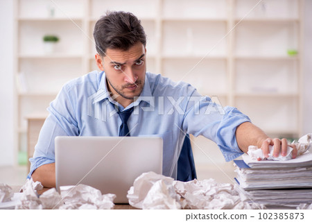 Young male employee in brainstorming concept 102385873