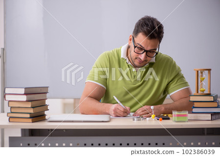 Young male student preparing for exams in the classroom Young male student preparing for exams in the classroom 102386039