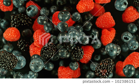Top shot of berries mix flying up in the air. Top shot of berries mix flying up in the air. 102386151
