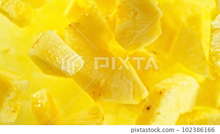 Top shot of pine apple slices flying up in the air. Top shot of pine apple slices flying up in the air. 102386166