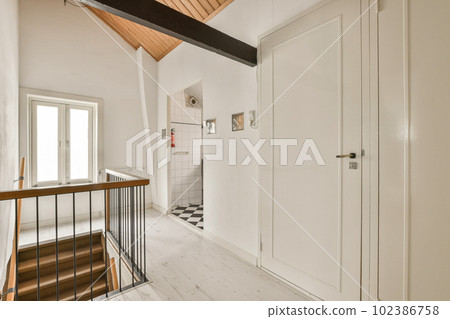 a room with white walls and wood flooring that has been stripped down to make it look like an attic 102386758